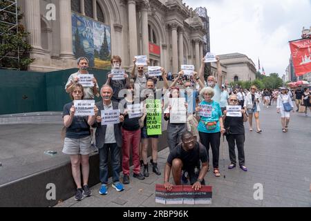 Members of Extinction Rebellion NYC and Rise and Resist with strips of tape on the mouth, on which they had written words such as 'Earth', 'glaciers' and 'famine' hold signs reading 'No art on a dead planet' pose for photos during a solidarity protest. Extinction Rebellion NYC and Rise and Resist stage a protest calling to drop charges against Joanna Smith and Tim Martin in front of the Metropolitan Museum of Art in New York City. Joanna Smith and Tim Martin smeared paint on the case of a Degas sculpture during an act of civil disobedience at National Gallery of Art in Washington, DC. Stock Photo