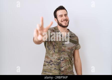 PORTRAIT OF INDIAN SOLDIER DRESSED IN UNIFORM FLASHING A VICTORY SIGN Stock  Photo - Alamy