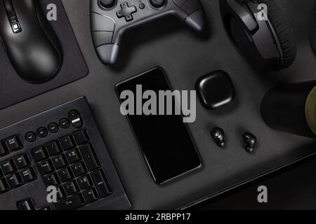 Various modern devices on black desk Stock Photo