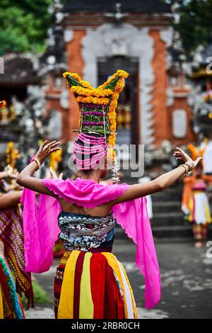 A young woman in traditional dress dancing for the festival Gulangan in Karangasem Bali Indonesia Stock Photo
