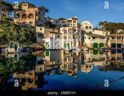 Fishermen's houses with boat garages and villas on the shore of the bay, Cala Figuera, Santanyí, Mallorca, Spain Stock Photo