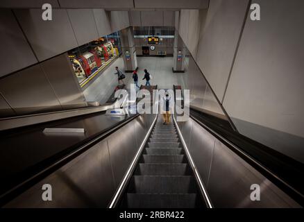 Battersea, London, UK: Escalator at Battersea Power Station underground station on the Northern Line with tube train Stock Photo