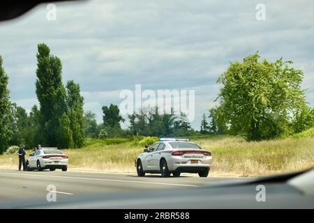 Two Dodge Charger Oregon State Police cars stopped on I-5 North Oregon USA Stock Photo