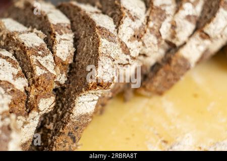 close-up view of some freshly cut slices of whole grain rye bread. Whole grain rye bread is made from all parts of the rye grain and has potential hea Stock Photo