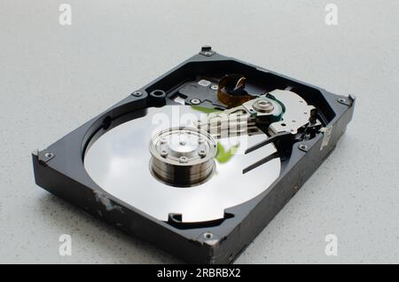 Close-up view of an open HDD, showing its magnetic disks and read heads. Digital storage technology. Stock Photo