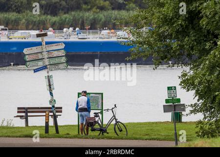Barendrecht, the Netherlands - 2021-09-02: An elderly man checking the route for his cycling trip along the river Stock Photo