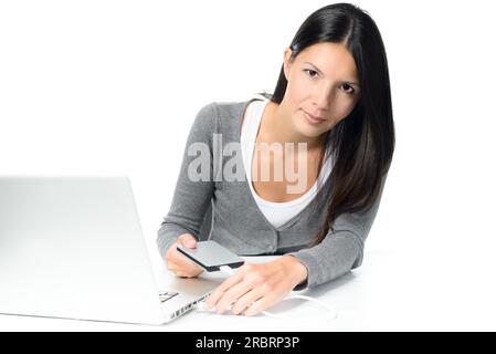 Young Gorgeous Woman Connecting Portable External HDD to Laptop Computer While Looking at the Camera, Isolated on White Background Stock Photo