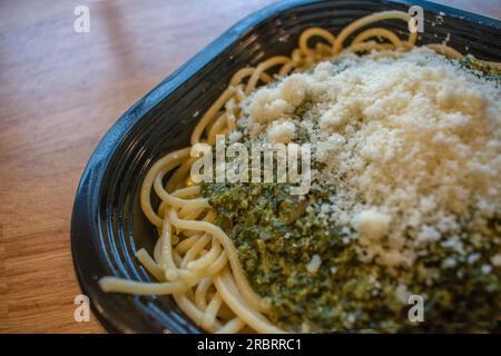 Taste the freshness of Italian spaghetti smothered in a delightful spinach sauce and topped with Parmesan cheese. Stock Photo