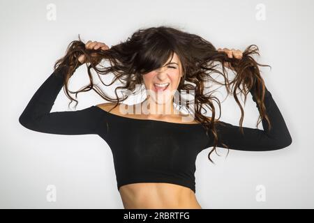 A dark haired model screaming, showing emotion Stock Photo