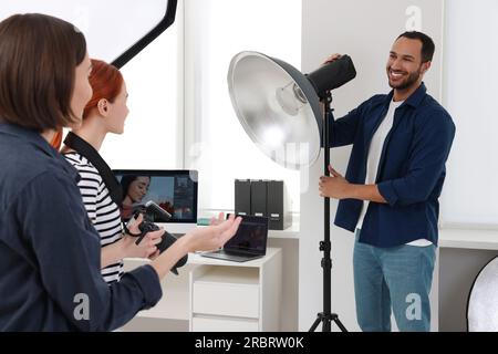 Young professional photographers working in modern photo studio Stock Photo