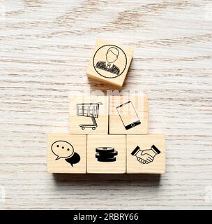 Professional buyer. Cubes with different icons on wooden table, top view Stock Photo