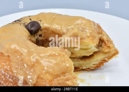 Gourmet doughnut on a white plate close up shot. Stock Photo