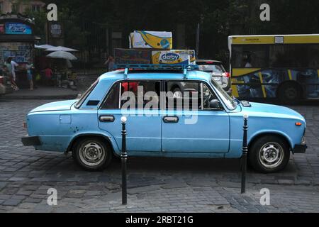 Picture of a decaying soviet car, a VAZ 2106 Zhiguli, a blue lada parked in the Lviv market in Ukraine. The VAZ-2106 Zhiguli is a sedan produced by th Stock Photo