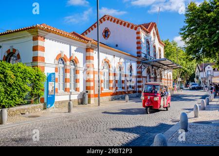 Tuk tuk with tourists in front of Sintra Train Station, town of Sintra, Portugal Stock Photo