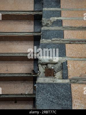 Bangkok, Thailand - Jul 08, 2023 - View of The old cement staircase is in the abandoned building and was left to deteriorate over years. Copy space, S Stock Photo