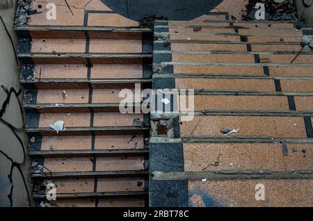 Bangkok, Thailand - Jul 08, 2023 - View of The old cement staircase is in the abandoned building and was left to deteriorate over years. Space for tex Stock Photo