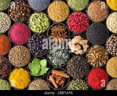Various spices and herbs as a background. Colorful condiments in cups, top view Stock Photo