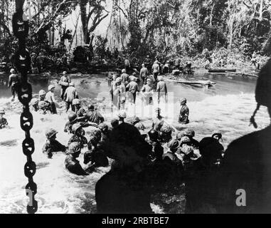 Bismarck Archipelago, Papua New Guinea:  1943 U.S. Coast Guardsmen and Marines buid a causeway for unloading on New Britain Island  as the preparations for the invasion of Cape Gloucester get underway. Stock Photo
