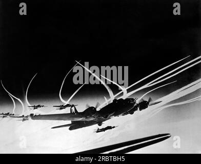 Europe,  January 20, 1944 B-17 Flying Fortresses of the US Army 8th Air Force and accompanying fighter planes leave vapor trails in the sky as they head on another bombing raid of Hitler's 'Fortress Europa'. Stock Photo