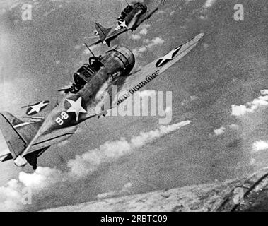 Midway Island,  June, 1942 Two US fighter planes fly over a burning Japanese ship during the Battle of Midway. Stock Photo