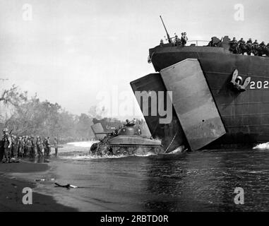 Cape Gloucester, New Britain, Papua New Guinea, December, 1943 A tank splashes out of the open doors of a Coast Guard LST during the invasion of Cape Gloucester. Stock Photo