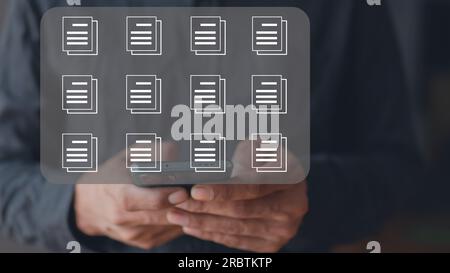 Businessman touching documents folder on a mobile screen. extension of digitization and process automation for managing files Stock Photo