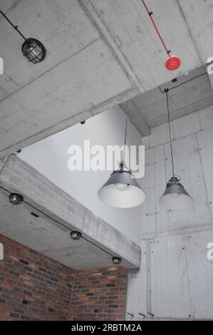 Close up concrete wall, industrial loft metal old black lamp , black cable on the wall, industrial interior design, copy space, black and cable on top Stock Photo