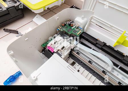 Itaja, Goias, Brazil - 09 05 2023: Open home multifunction printer for maintenance electronic components Stock Photo