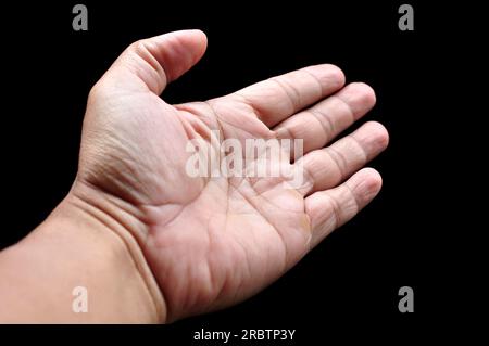 Asian man palms wide open fingers black background Stock Photo