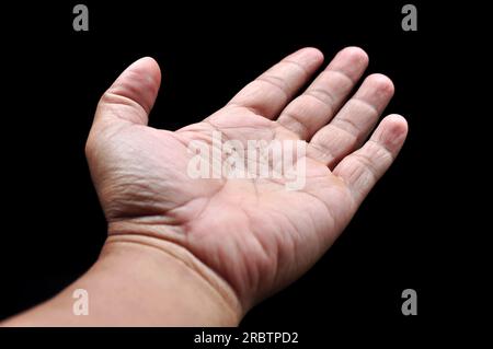Asian man palms wide open fingers black background Stock Photo