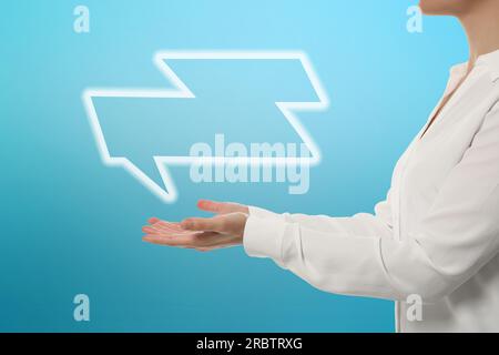 Communication and dialogue concept. Woman with illustration of speech bubble on light blue background, closeup Stock Photo