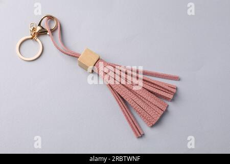 Pink leather keychain on light grey background, above view Stock Photo