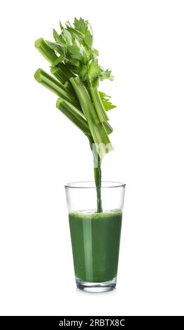 Pouring freshly squeezed juice from celery into glass on white background Stock Photo