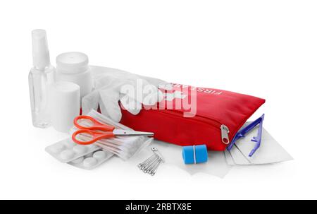 Red first aid kit, scissors, pins, gloves, cotton buds, pills, hand sanitizer, plastic forceps and elastic bandage isolated on white Stock Photo