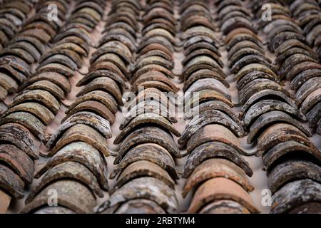 Close-up image of the roof of a building covered with old tiles. Stock Photo