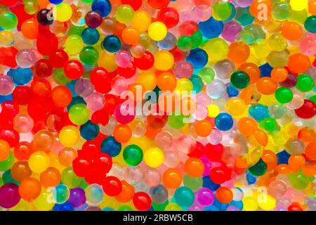 Lots of different colored hydrogel balls. Set of multicolored orbis.  Crystal water beads for games. Helium balloons. Can be used as a  background. Poly Stock Photo - Alamy