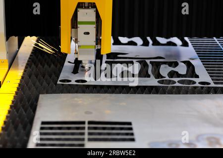 Metal cutting with CNC laser cutting machine. Selective focus. Stock Photo