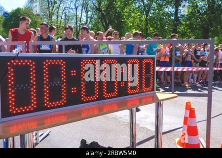 Sports electronic board on start. Runners at the start. Marathon. Countdown. Electronic stop watch, Digital  scoreboard. The concept of time is over, Stock Photo