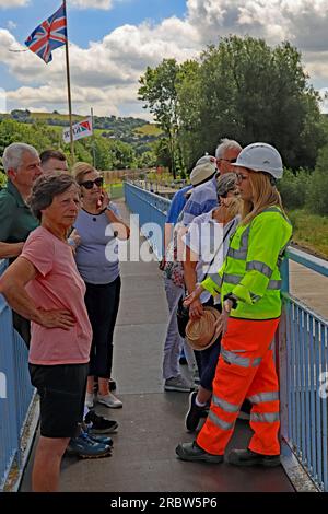 Helen from the Canal and River Trust is answering questions from a group of visitors to a public open day to the repair work at Toddbrook reservoir Stock Photo