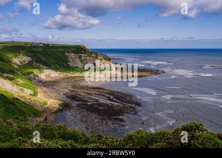 The beautiful bay where Port Mulgrave is located. This clifftop view is from the Cleveland Way footpath between Port Mulgrave and Runswick Bay Stock Photo