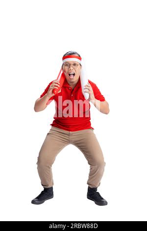 Indonesian man supporting Indonesian team when competing isolated over white background Stock Photo