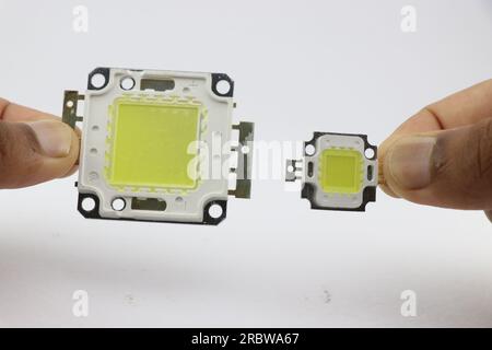 High power SMD white lighting LEDs of different sizes held in the hand isolated on white background Stock Photo