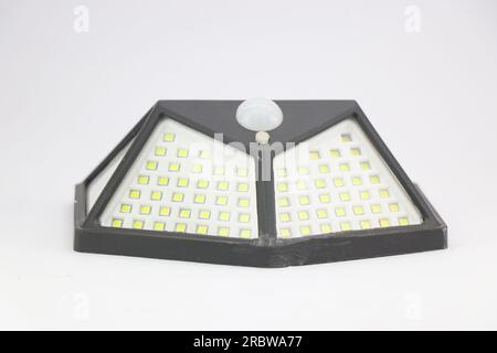 Solar light or a solar powered garden light with a motion sensor and a led panel isolated on white background Stock Photo