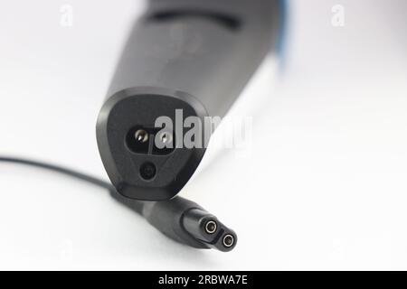 Charging point of a hair trimmer machine and the power plug point of the charger isolated on white background Stock Photo