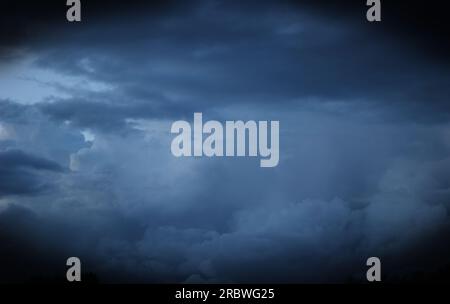Heavy and dark clouds in the evening with vignetting. Stock Photo