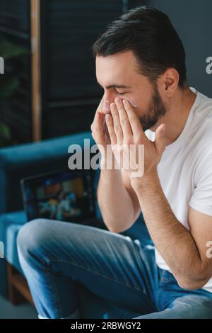 Young man covering face with hand frustrated Stock Photo