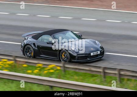2020 Porsche 911 Turbo S S-A T 650 PDK 8 Auto Start/Stop Black Car Cabriolet Petrol 3745 cc travelling at speed on the M6 motorway in Greater Manchester, UK Stock Photo