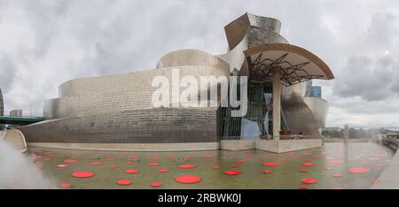 Bilbao Spain - 07 05 2021: Panoramic exterior view at the iconic Guggenheim Museum Bilbao, an iconic museum of modern and contemporary art, Nervion ri Stock Photo