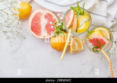 Top view of aesthetic cocktails with citrus fruits. Vitaminized summer detox water. Low alcohol, zero proof drinks. Copy space. Stock Photo