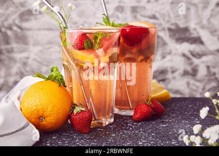 Aesthetic refreshing cocktails with citrus fruits and strawberries. Vitaminized summer detox water. Low-alcohol drinks. Stock Photo